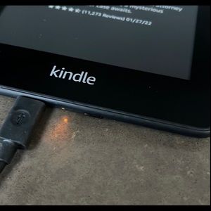 Kindle with cord for charging.